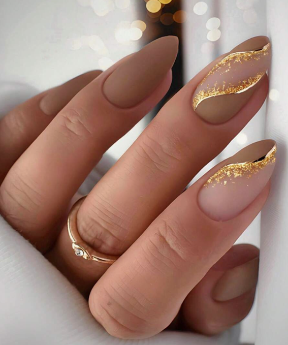 Gold glitter design on a neutral nails colour